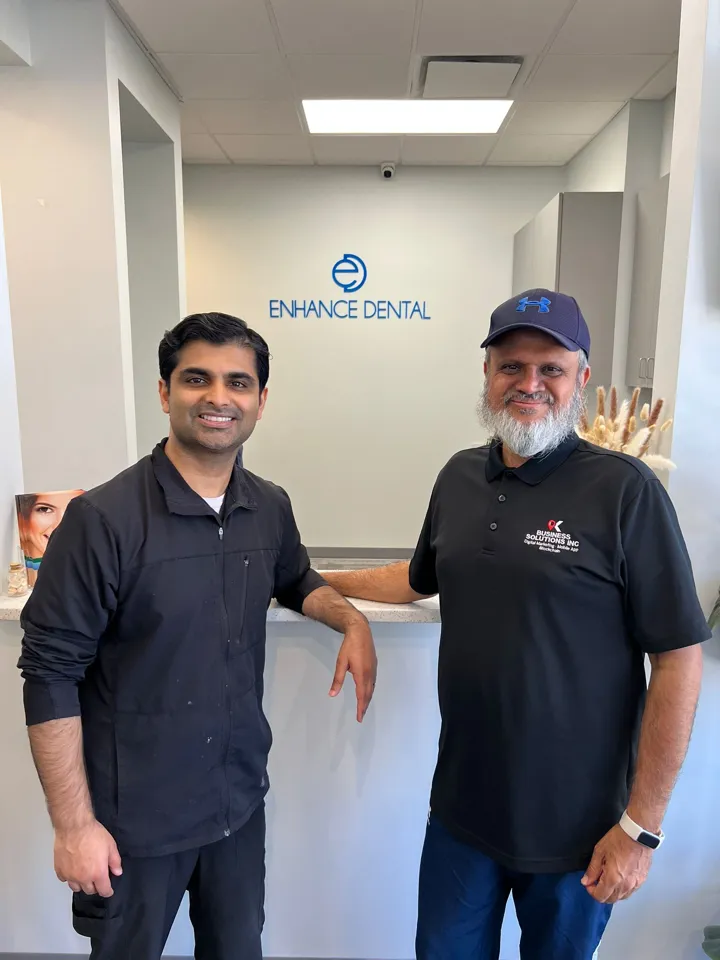 Amir Rangwala with a dental practice client at their front desk
