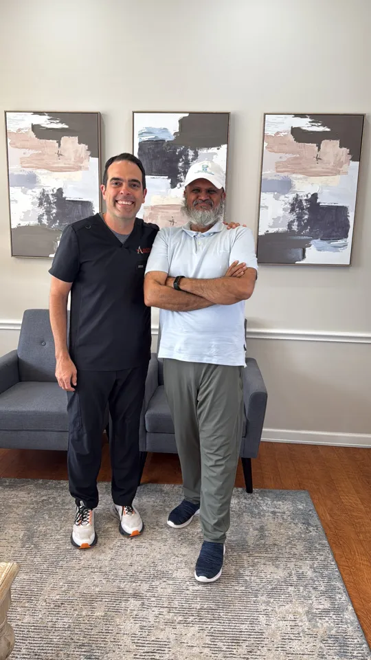 Amir Rangwala with a dentist client in their practice lobby