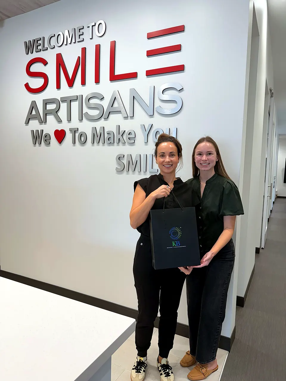 Avery Brown delivering a K Business Solutions Inc. welcome gift to Smile Artisans in Cypress, Texas