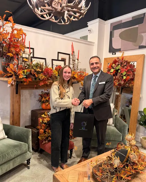 Our team member shaking hands with a client in their showroom