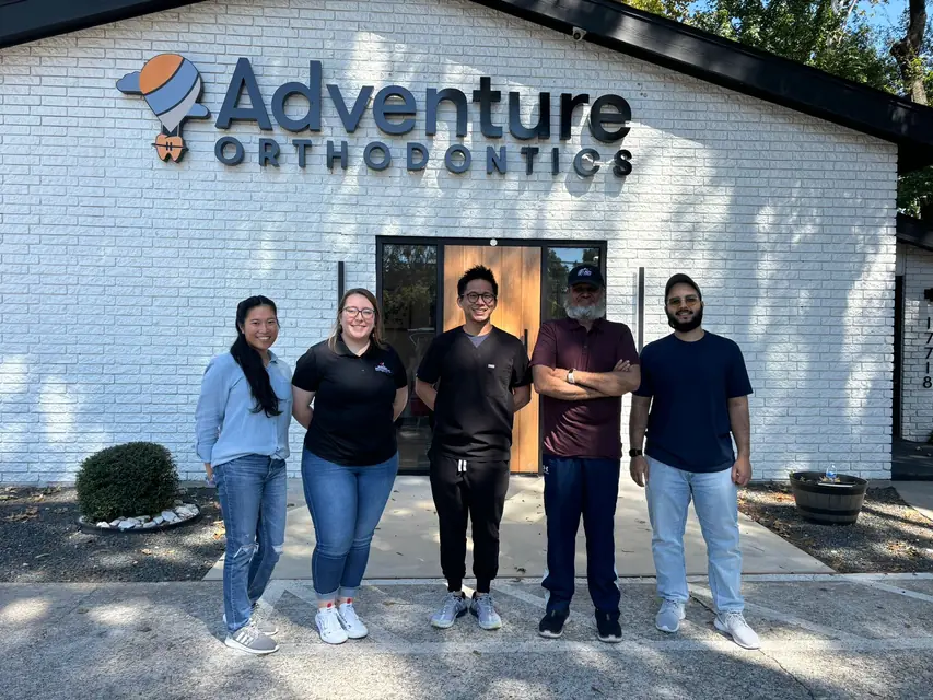 Our team with an orthodontics client outside their office